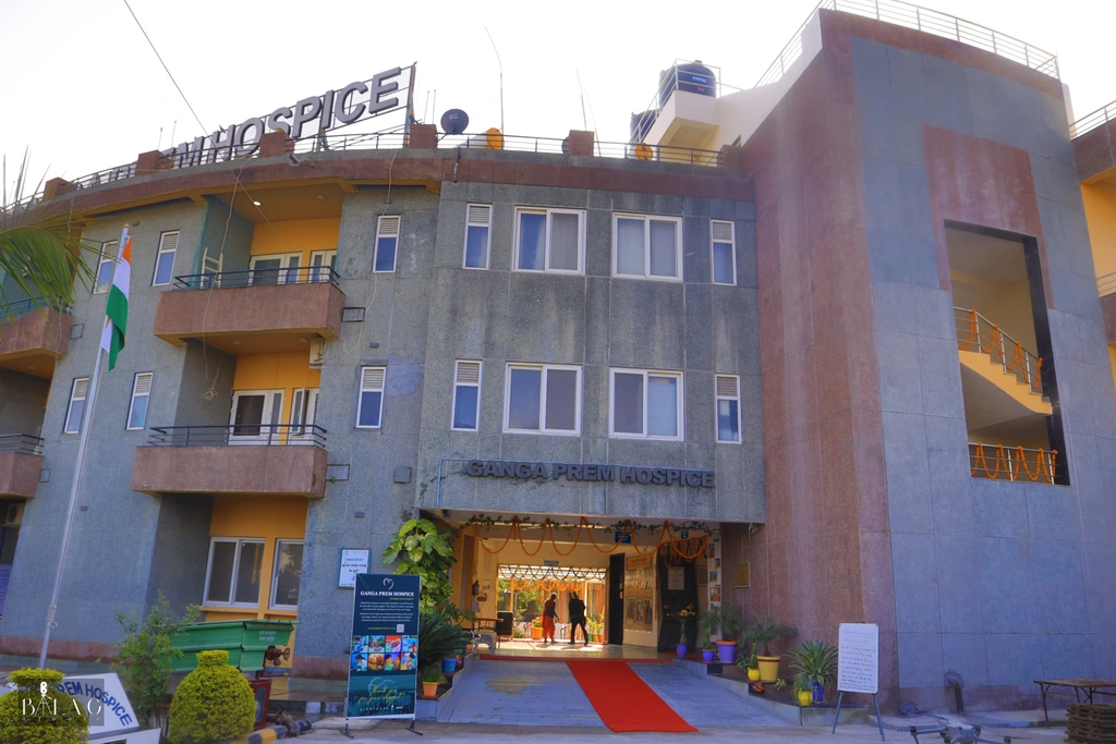 Ganga Prem Hospice inpatient facility building in Rishikesh, set against the Himalayan foothills